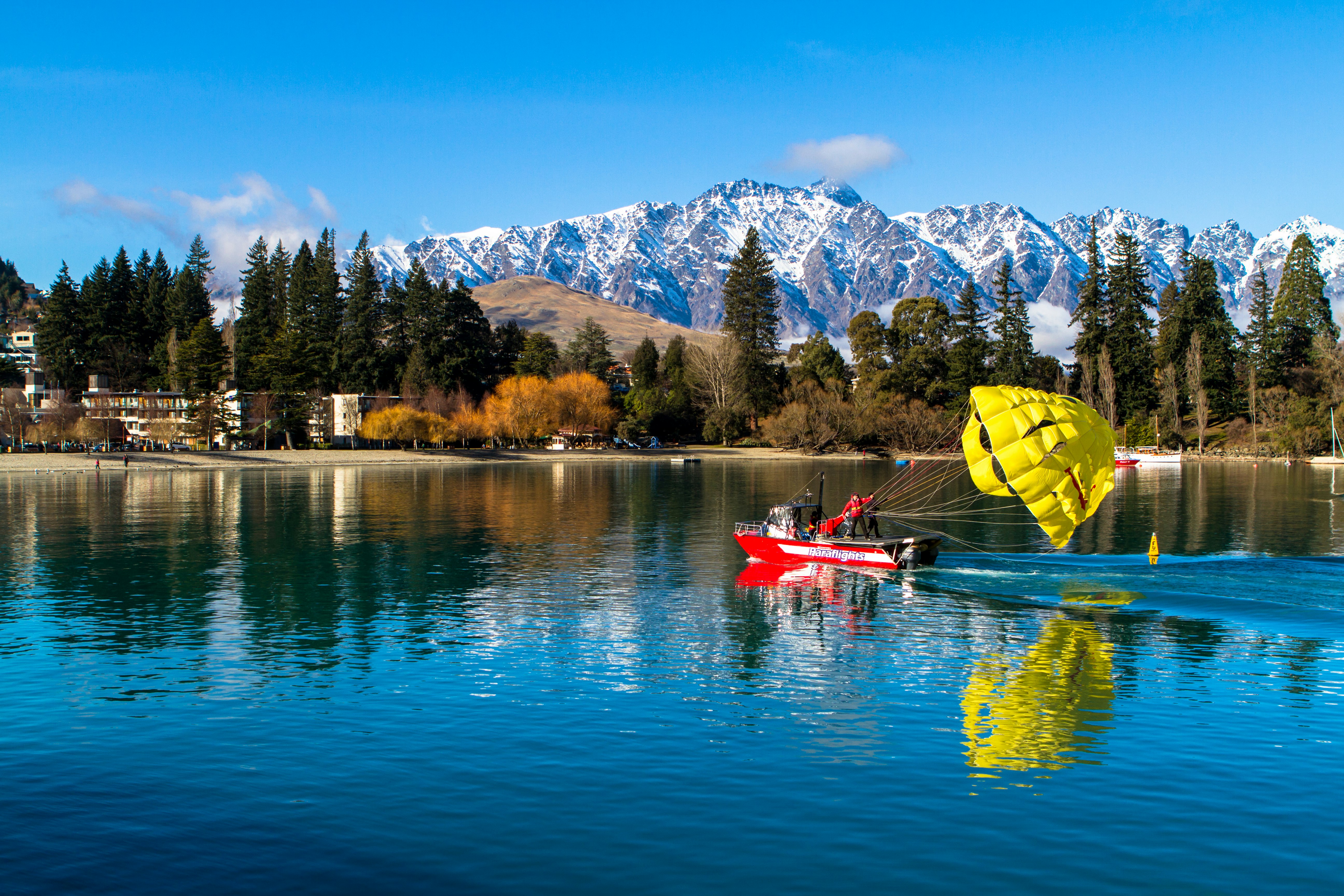 landscape photography of body of water near snowy mountain